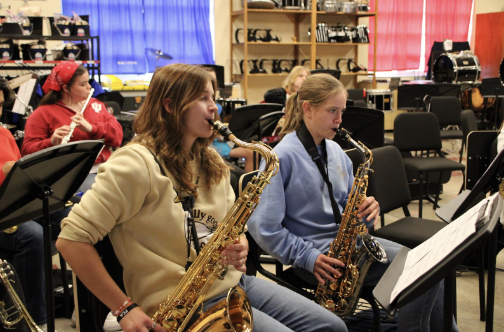 Megan Comer and Ellie Bishop play a song on their saxophones during Jazz Band practice.  ’A Night in Tunisia’ is by far our most difficult song because it has multiple style changes within the song, and the chords are very difficult to improvise, “ Comer said. 